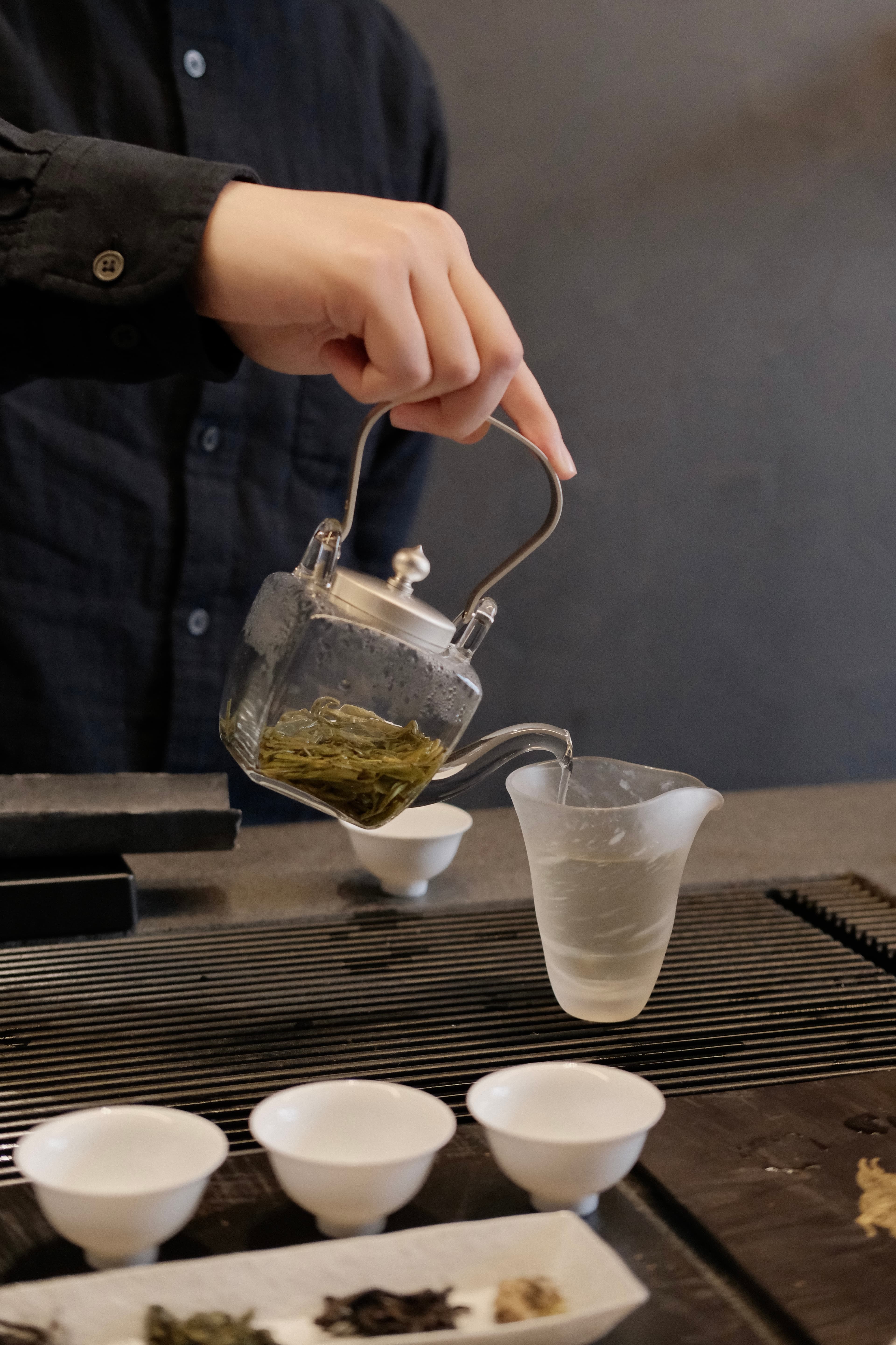 Tea host pouring tea.